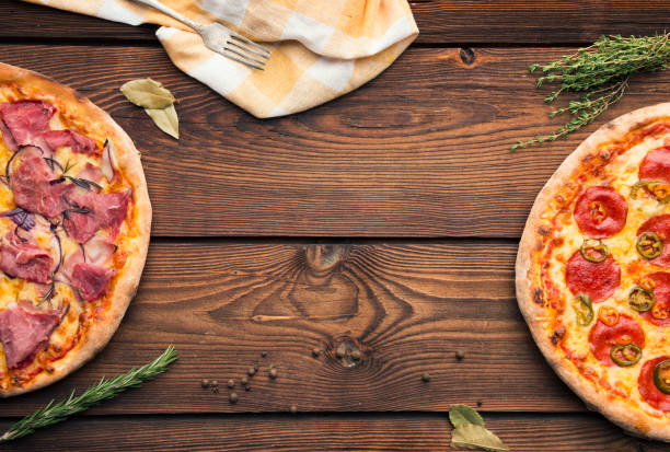 istock Italian pizza served on wooden table 888154212