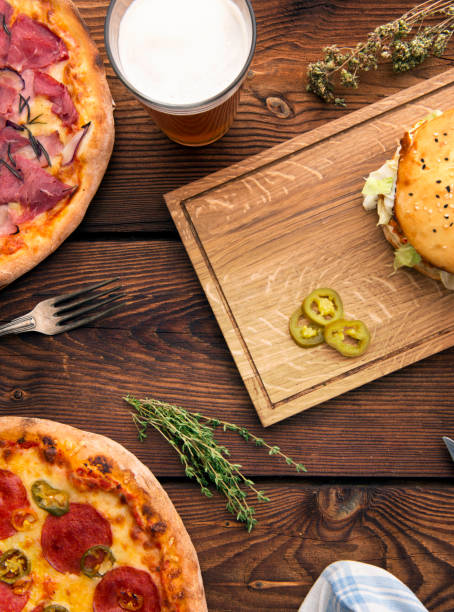 istock Pizza and hamburger on wooden background 888154404