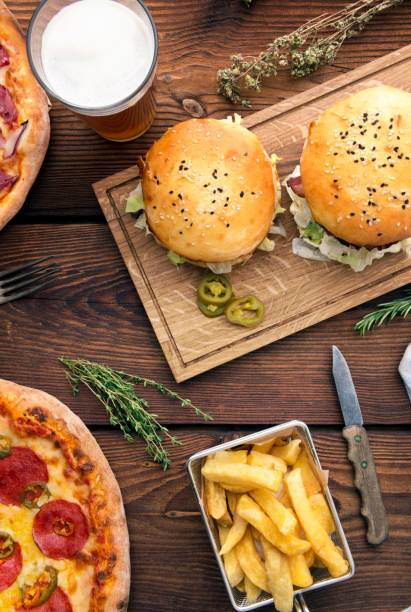 istock Pizza and hamburger on wooden background 888154458
