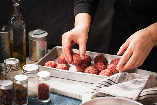 Chef preparing raw meatballs hands cooking process