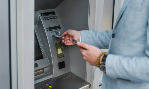 istock Young entrepreneur using an ATM maschine. 888158806