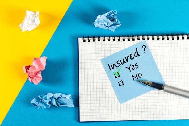 Survey with question Insured, Yes or no. Message at notepad at yellow and blue table, insurance agent Survey with question Insured, Yes or no. Message at notepad at yellow and blue table, insurance agent. general military rank stock pictures, royalty-free photos & images