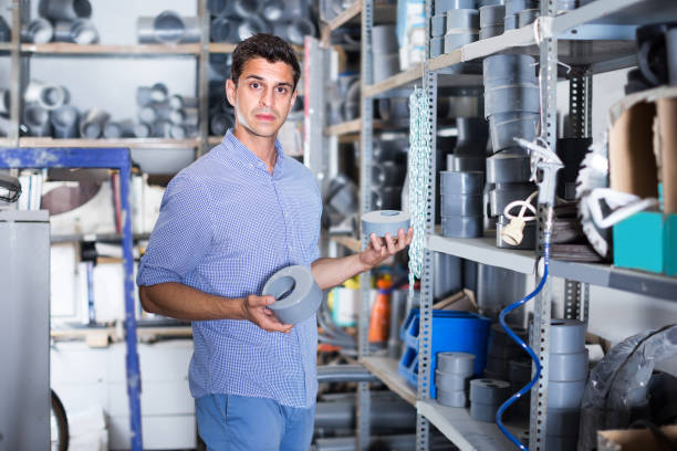 istock Seller is checking plastic trumpet for plumbing works 888173972