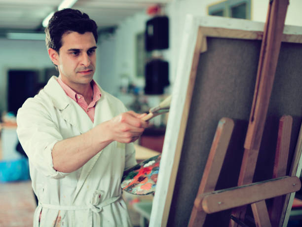 istock Artist painting on canvas 888182754
