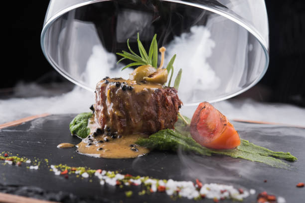 grilled beef fillet medallion with  pesto sauce and tomato