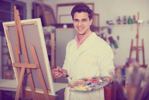 istock Artist painting on canvas 888182954
