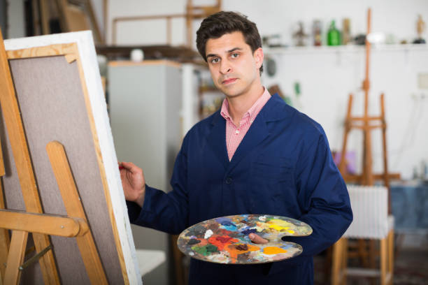 istock Artist painting on canvas 888182962