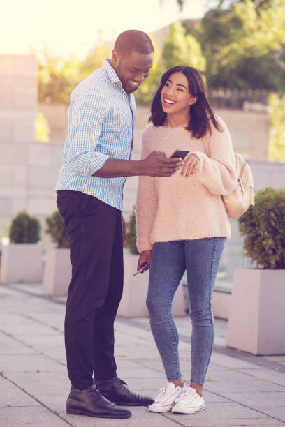 istock Cheerful positive man holding his smartphone 888183238