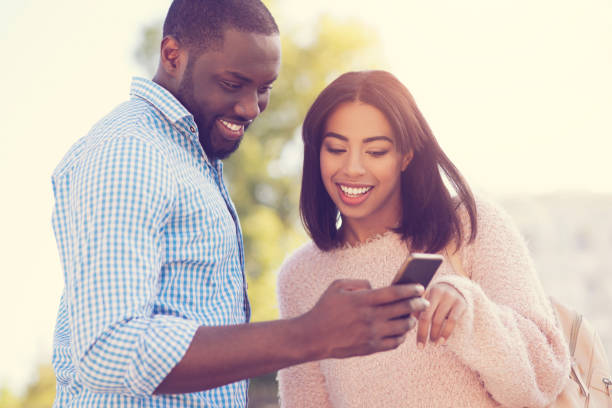 istock Cheerful young people looking at the smartphone screen 888183764