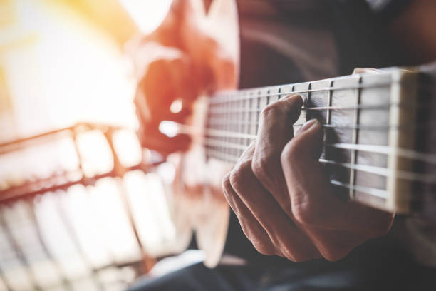 istock Close-Up Of Man Playing Guitar 888187166
