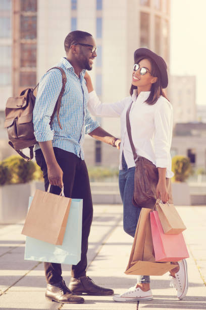 istock Joyful positive couple holding bags 888196854