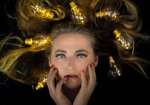 istock A young woman is surrounded by lights 888197634