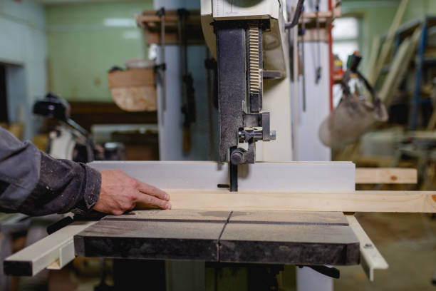 istock Hands saw a bar on a jigsaw machine. Side view 888199748