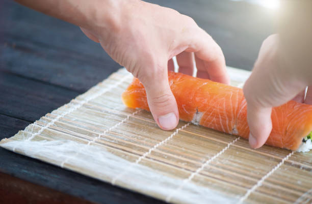 istock closeup of chef hands rolling up sushi 888200242