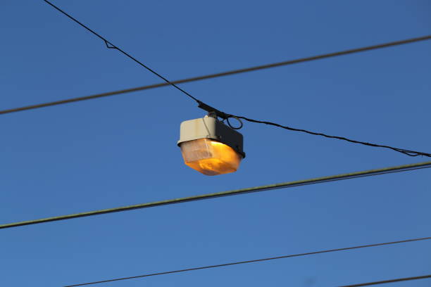 istock Low Angle View Of Illuminated Lamp Against Clear Blue Sky 888200706