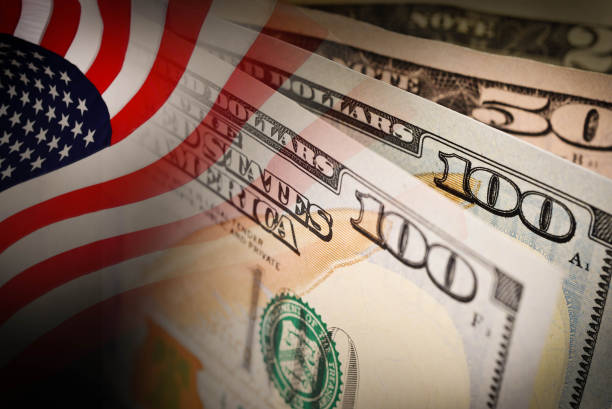 American flag and banknotes (USD) currency money stock photo