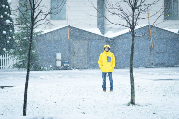istock Male with yellow ski coat walking on the snow 888204722