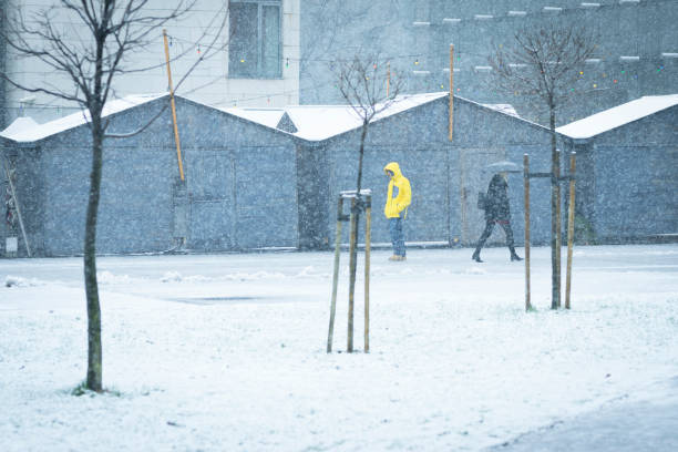 istock Male with yellow ski coat walking on the snow 888204752