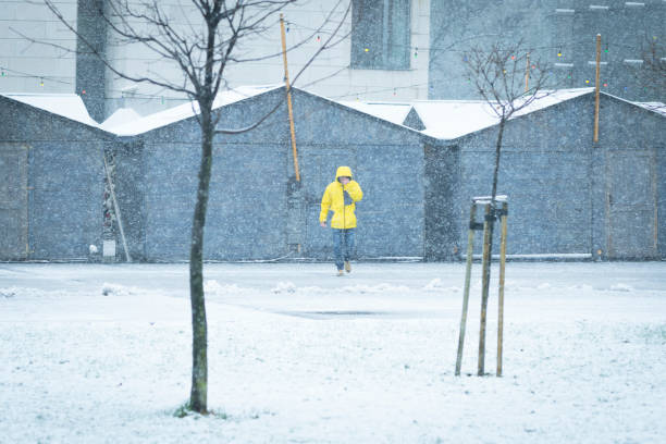 istock Male with yellow ski coat walking on the snow 888204992
