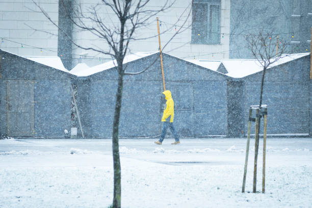 istock Male with yellow ski coat walking on the snow 888205016