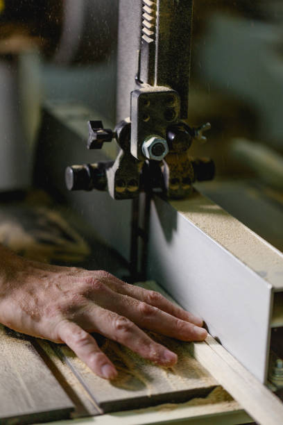 istock The hand held the full beam through the jigsaw machine 888205104