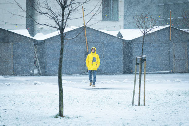 istock Male with yellow ski coat walking on the snow 888205282