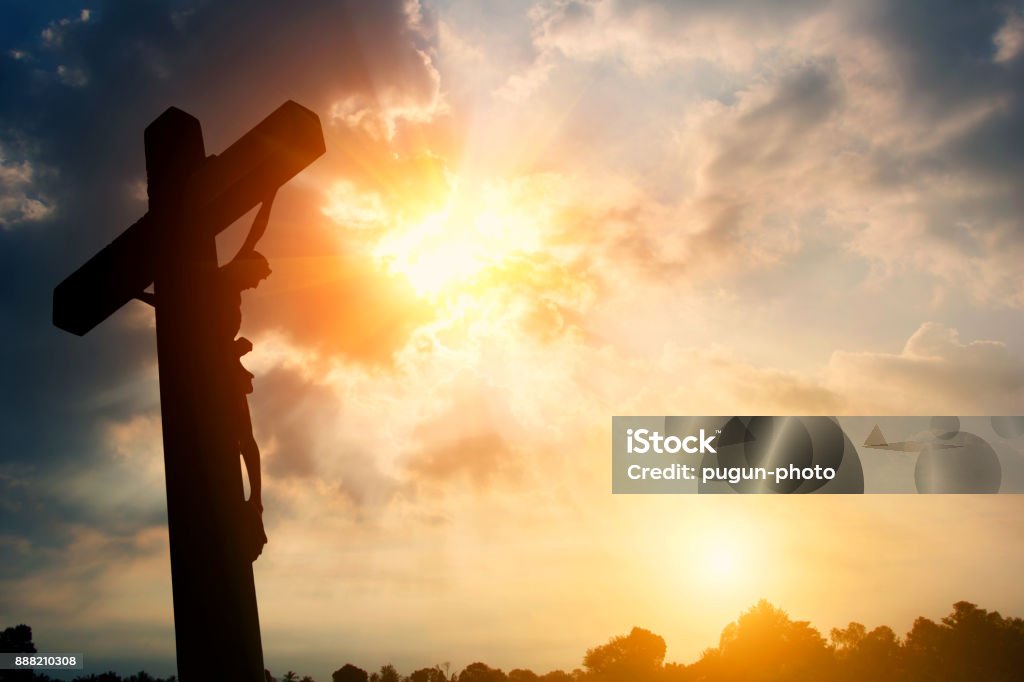 Silhouette Crucifixion of Jesus Christ and the sunset Jesus Christ Stock Photo