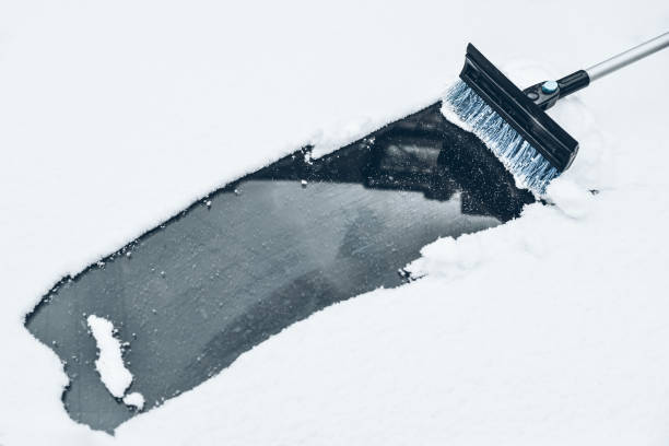 istock cleaning car from a snow 888217396