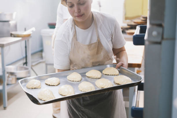 istock Cook puts pies into stove for baking 888226640