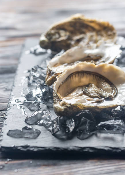 istock Raw oysters on the black stone board 888226892