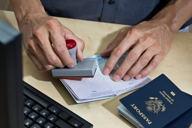 U.S. Border Security, Homeland Security, Passport Inspection Station for Immigration A U.S. border Security agent, inspecting passport at the U.S. customs and Border Protection station. A concept photo for the Homeland Security, immigration and naturalization process. customs official photos stock pictures, royalty-free photos & images