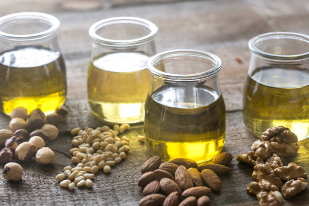 istock Glass jars with different kinds of nut oil 888227582
