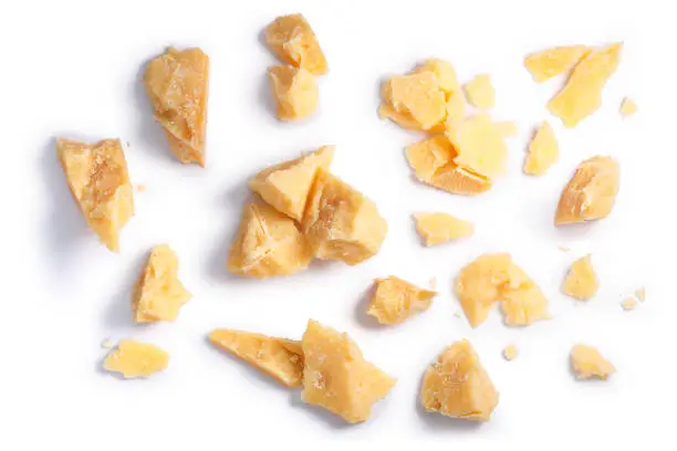 Hard mature cheese (Parmesan, Parmigiano), rough pieces, piles, crumbs. Clipping paths, shadow separated, top view