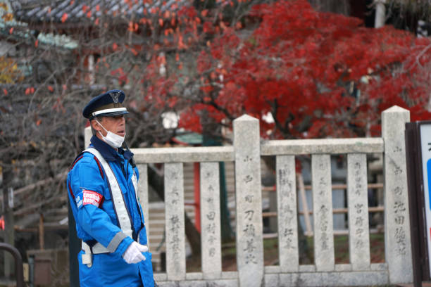 Japanese Traffic Police In Blue Uniform Performing Duties On The