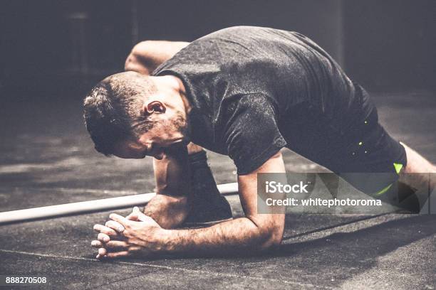 Guy Starts Training Preparation By Doing Streatching Stock Photo - Download Image Now