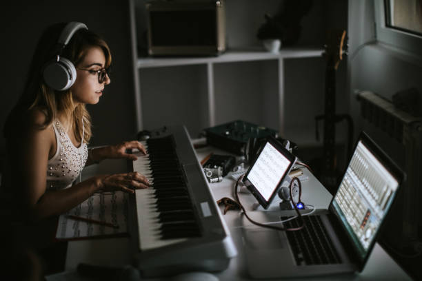 Female Musiciasn Creating Music Pretty Young Woman Playing Music At Home composer photos stock pictures, royalty-free photos & images