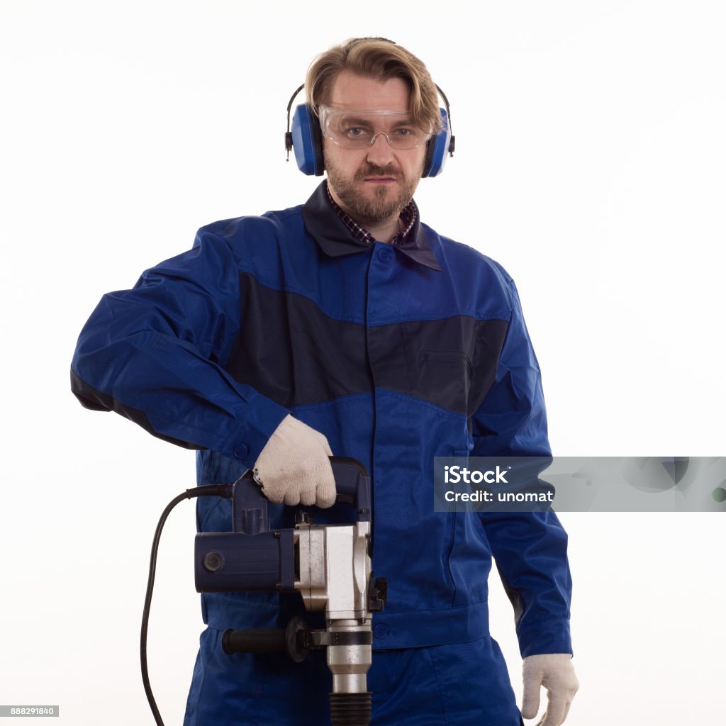 Construction worker stands leaning on the puncher on a white background Construction worker stands leaning on the puncher on a white background. 30-39 Years Stock Photo