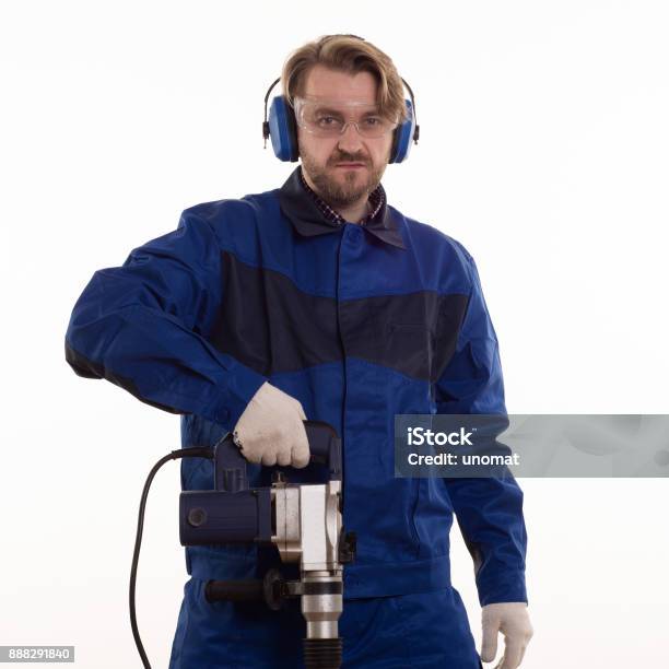 Construction Worker Stands Leaning On The Puncher On A White Background Stock Photo - Download Image Now