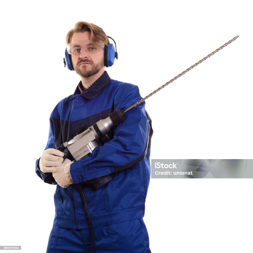 attractive construction worker wearing safety goggles and headphones gently holds a puncher attractive construction worker wearing safety goggles and headphones gently holds a puncher on a white background 30-39 Years Stock Photo