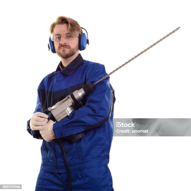 Attractive Construction Worker Wearing Safety Goggles And Headphones Gently Holds A Puncher Stock Photo - Download Image Now