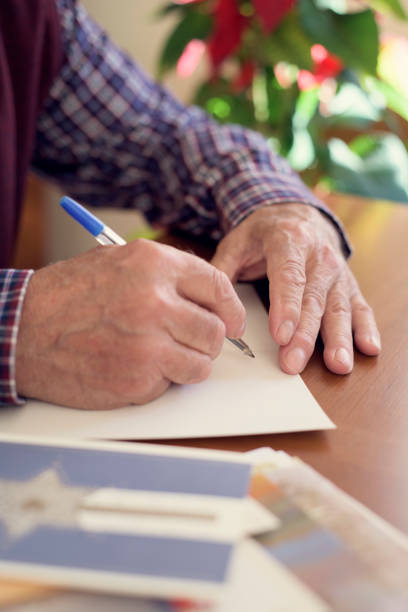 istock old man writing christmas cards 888292700
