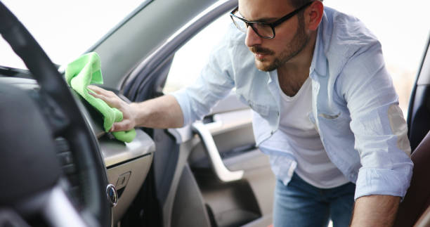 istock Person cleaning car with microfiber clot and maintaining shine 888303700