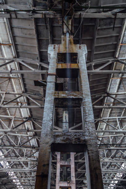 istock Rain in rotten abandoned large industrial hall. Water flows from pipe. Depression decay 888304456