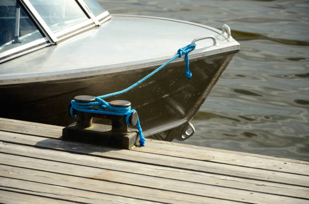 Cross bollard with blue rope on pier