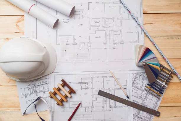 istock Architecture drawing desk, construction site working with blueprints in the office top view 888307954