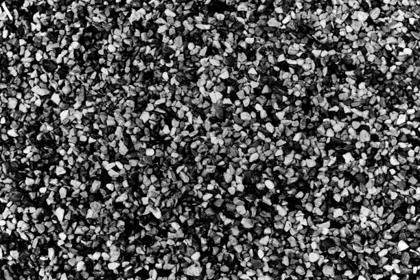 istock Small pebble or shingle background or texture black and white. 888314314