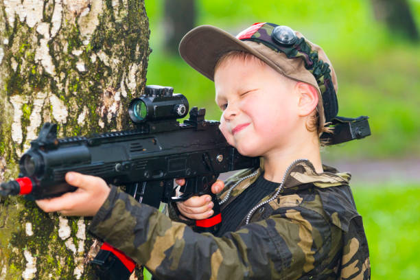 istock Boy with a gun playing laser tag 888324854
