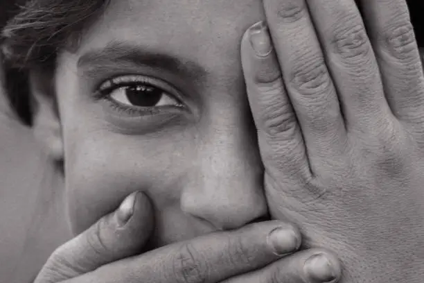 Photo of syrian girl showing one eye, mouth closed - close up