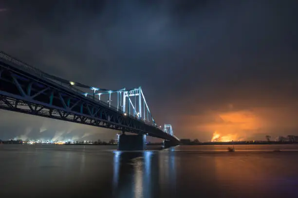 Nightshot Of Illuminated Historical Iron Bridge across the River Rhine at Krefeld Uerdingen View To Duisburg