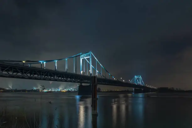 Nightshot Of Spotlighted Historical Iron Bridge across the River Rhine at Krefeld Uerdingen View To Duisburg